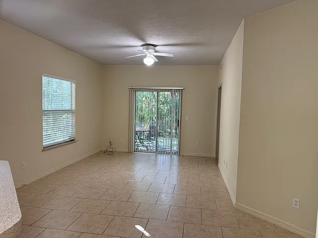 Living area overlooking a patio that is overlooking a natural preserve area.