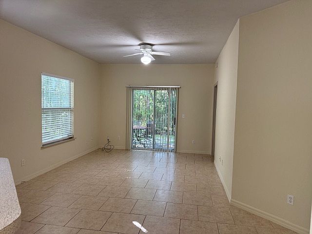Living area overlooking a patio that is overlooking a natural preserve area.