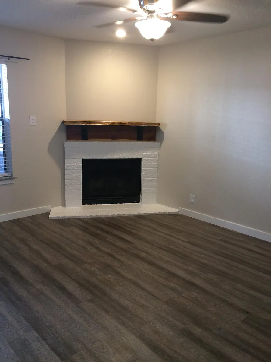 Living room with fireplace. Beautiful handmade red cedar mantle. - 929 W Hickory St