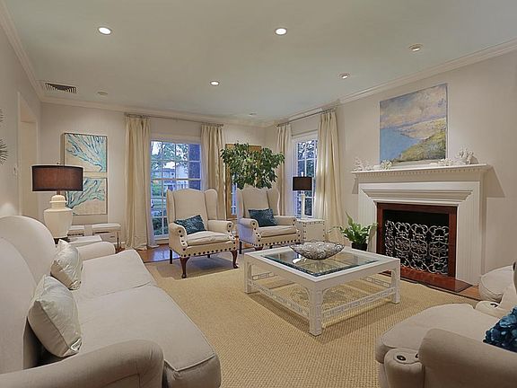 Spacious formal living room is filled with light and gorgeous views from the tall windows.
