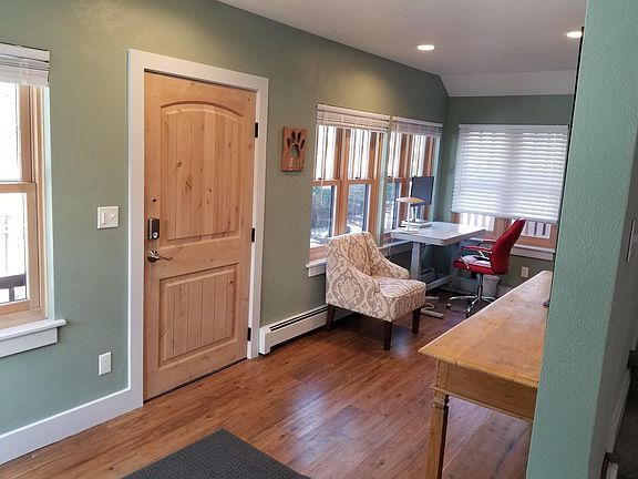 entrance and den, standing desk in the back
