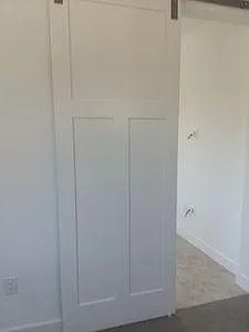 Sliding barn doors separate bedroom from other living areas