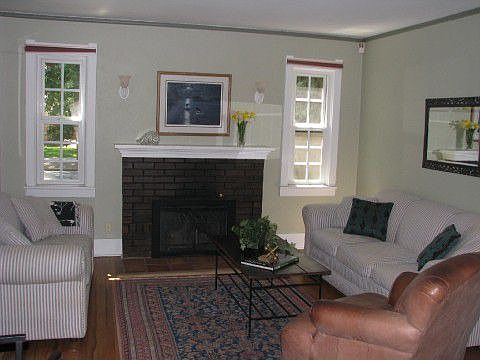 Living room has hardwood floors and fireplace