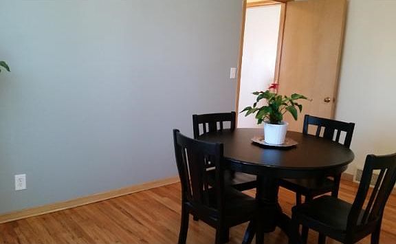 3rd main level bedroom currently set up as a cozy dining room.