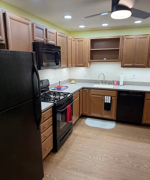 Lots of cabinets in large kitchen with gas stove, microwave hood and Bosch dishwasher
