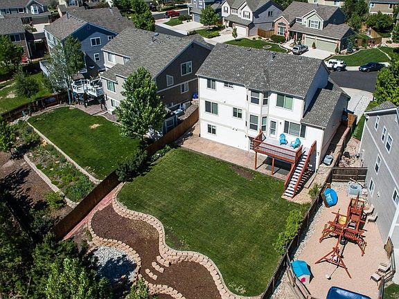 Vaulted-ceiling entry with hardwood floors leads into the open floor plan.