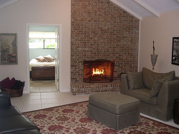 Living room w/ one of two wood burning fireplaces