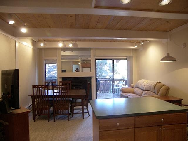 Open living floor plan with sunny deck off of living area.