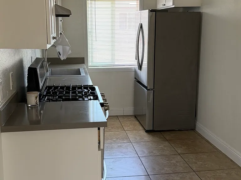 Kitchen with appliances - stainless steel stove and refrigerator