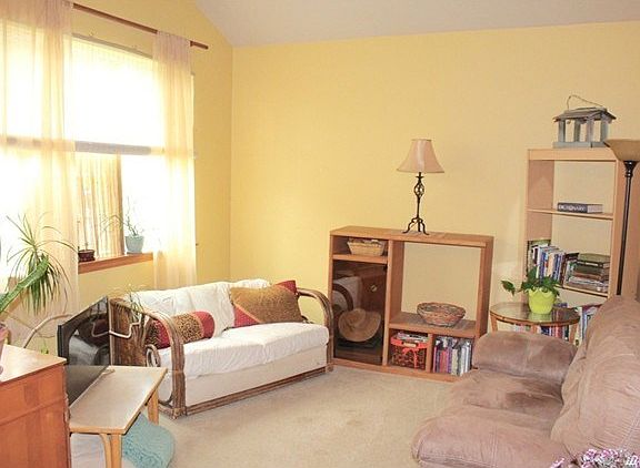 Sunny living room with vaulted ceilings off entry.  The perfect place to relax.