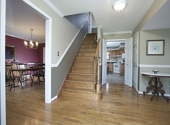 Formal Foyer w/ custom oak staircase, hardwood