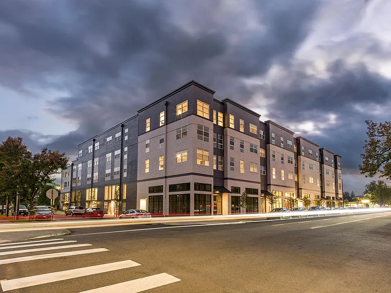 Modera Woodstock shines at twilight, showcasing modern design and inviting homes.