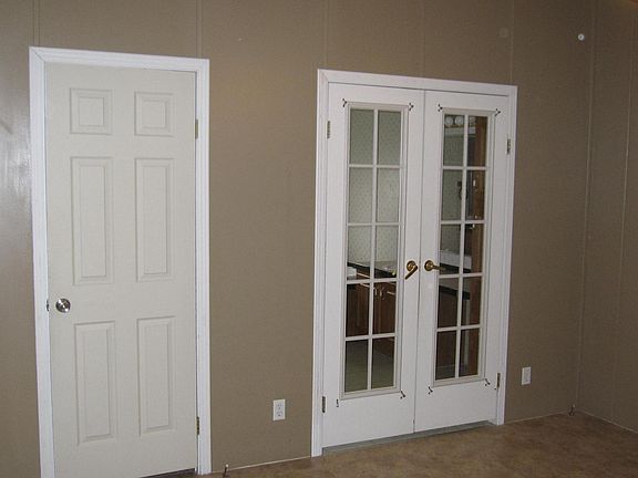 Master Bedroom - French doors to Master Bath seen to the right, and walk in master closet to the left.
