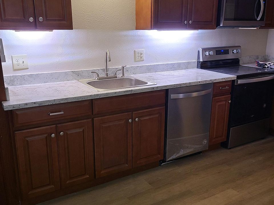 Kitchen with stove, microwave dishwasher and full size refrigerator and lots of counter space.