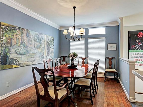 Formal dining room with hardwood flooring.
