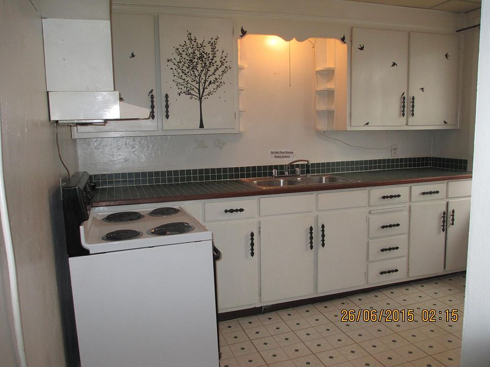 New Tile kitchen counter tops with a lot of cabinet storage.