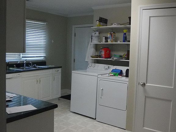 Kitchen: View of back door, laundry area and pantry. Water heater is new and is in the kitchen pantry. Shelving available above water heater.
