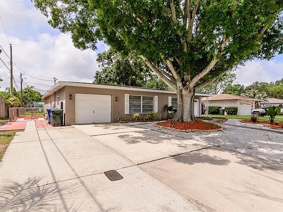 Oversized Driveway + Side Yard Parking Pad Creates Addt Vehicle Parking + RV & Boat Storage!