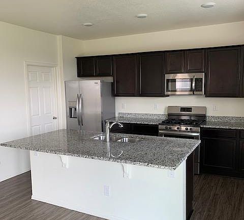 Modern kitchen with SS appliances, and oversized pantry.