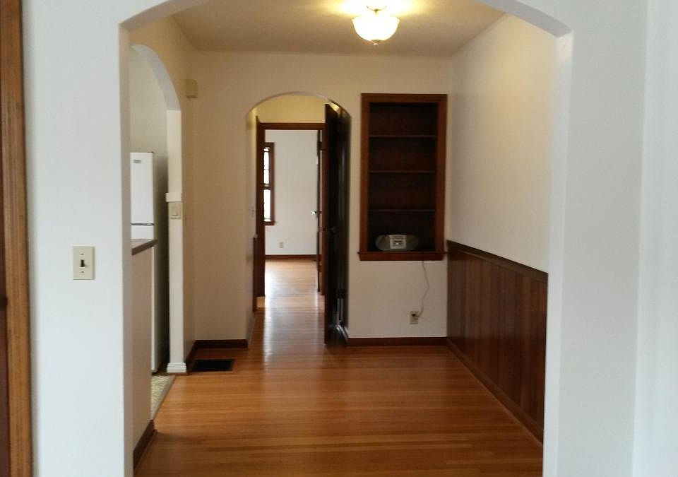 View looking down hallway and at dining area