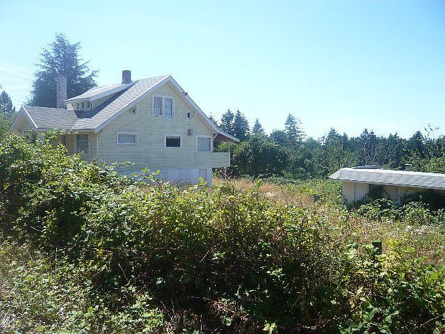 Side of home with detached three car garage