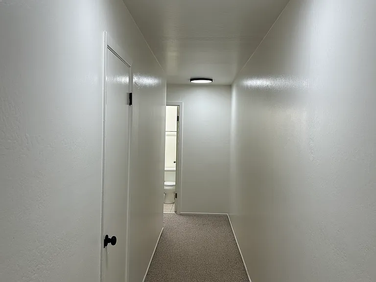 Front entrance hallway with a coat closet steps from the apartment door.