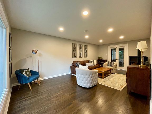 Living room with beautiful hardwood floor and a double door to the sunroom