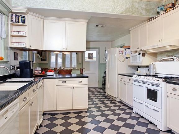 Upgraded Kitchen w/ caesarstone counter tops, tile flooring, and new appliances
