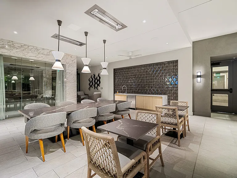Indoor lounge with marble accents, designer lighting, and seating