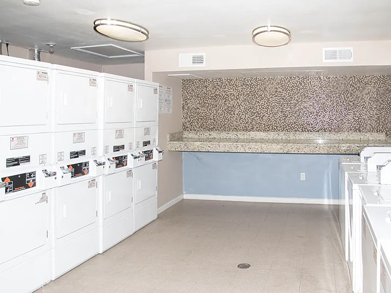 On-site laundry facility with modern machines and clean, spacious layout