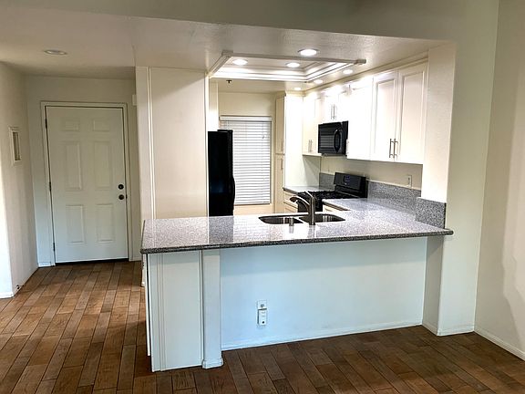 Kitchen and front door of condo