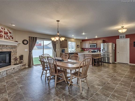 The kitchen and dining area feature a beautiful gas fireplace and a walk-out to