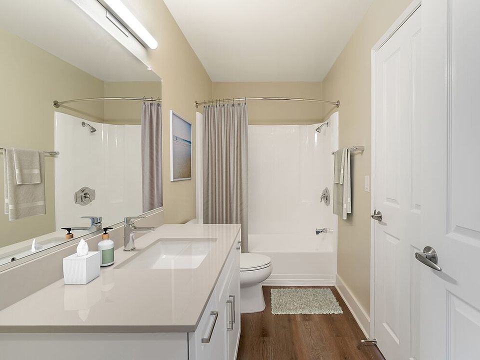 Renovated Package I bath with beige granite countertops, white cabinetry, and hard surface flooring