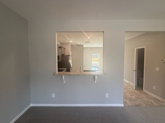 Kitchen looks into the great room. Bar top will accommodate 2 bar stools.