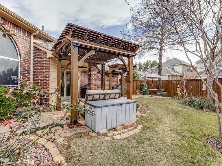 View of the backyard with a pergola.
