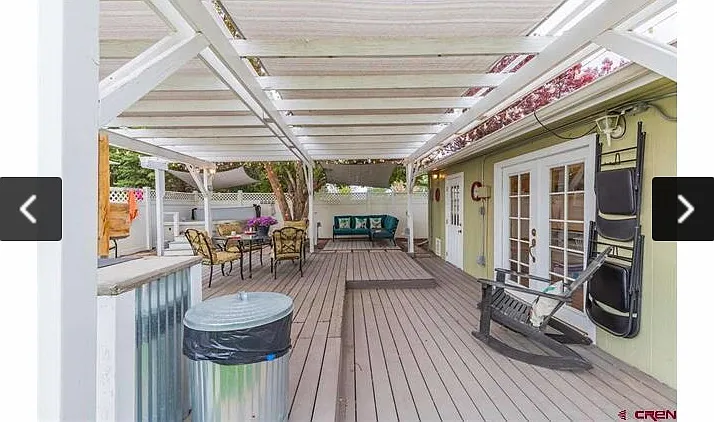 Porch with outdoor seating and grill. The single/double doors lead to the washer and dryer units, which are shared with the upstairs tenant.