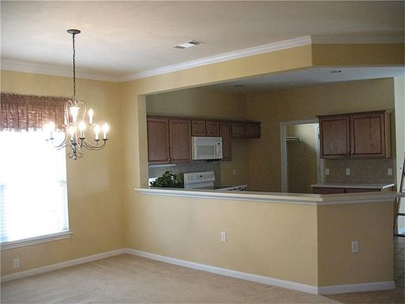 DINNING ROOM IS STEPS AWAY FROM THE KITCHEN FOR EASY ENTERTAINMENT.