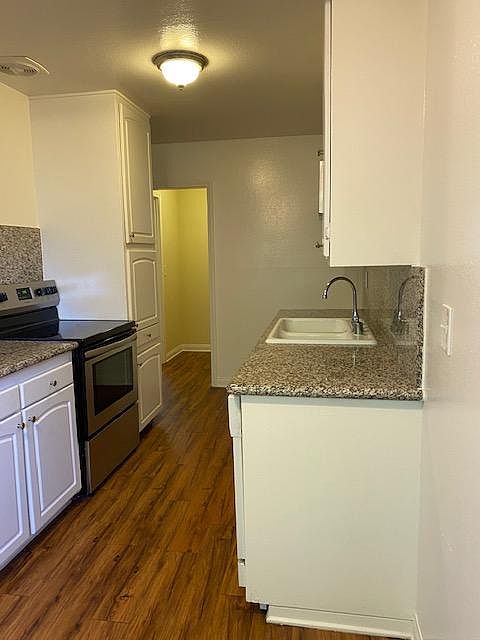 Beautiful galley kitchen offers brand new stove...tons of cupboards and granite counter space.