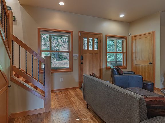 Beautiful entry with the wood detailed finishes, beautiful floors and unique design of the stair case. 