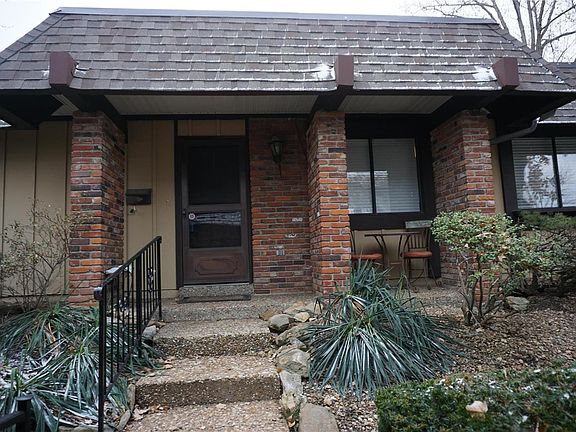 Covered porch and brick trim say welcome home!