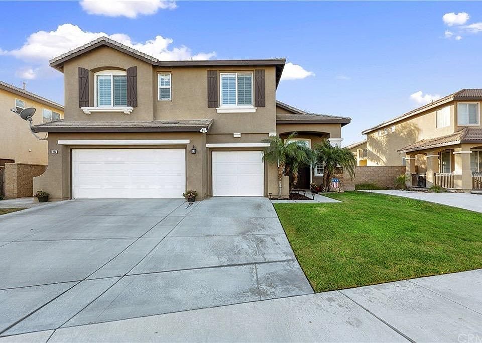 Front view of home with 3 car garage and large driveway