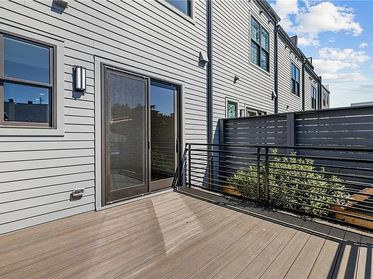 Back Patio (Note: Actual unit has light wooden floors and upgraded fixtures / appliances)
