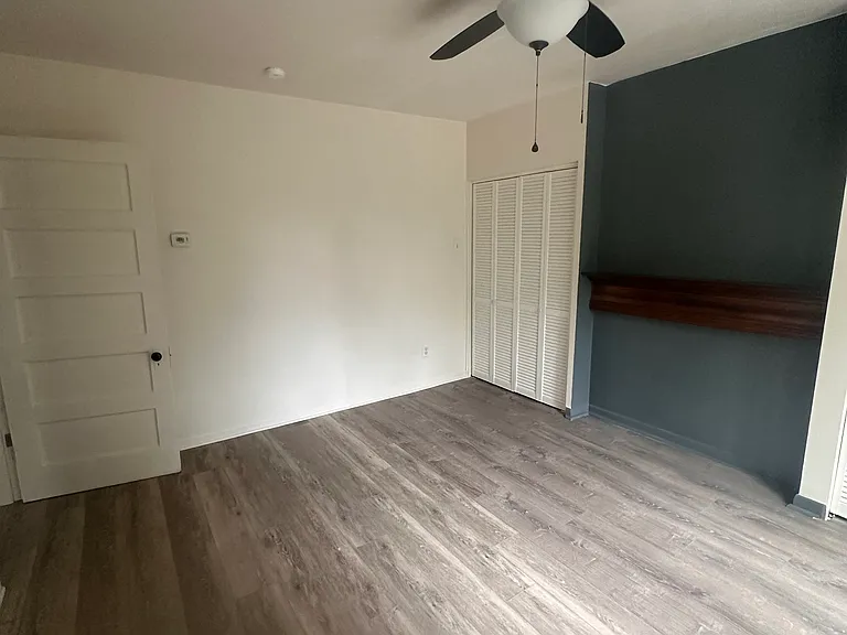 Bedroom 1 with beautiful flooring and large closets