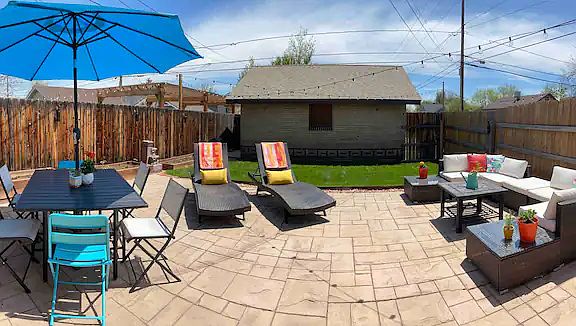 Sunny back patio with three raised beds and one-car garage (typically used for storage).