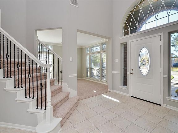 Welcoming entrance features high ceilings.