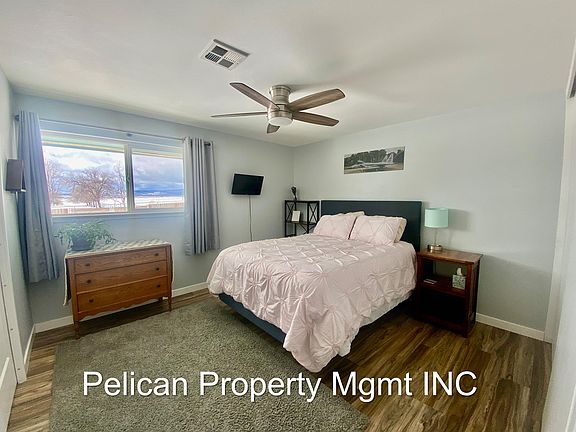 Master bedroom queen bed with pocket door to bathroom