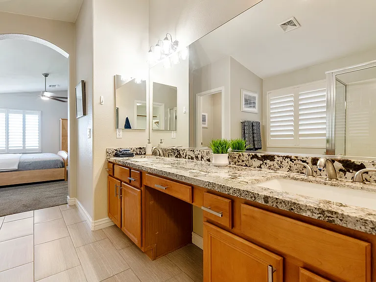 Primary bath with 2 sinks, large counter, shower, garden tub and walk in closet