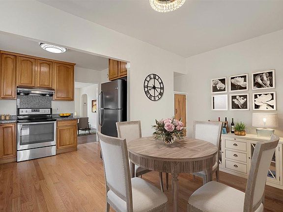 Adorable dining room allow for intimate dining above with a beautiful flush-mount mirror and crystal chandelier. Adds a lot of light to the space. 

(Furniture added digitally)