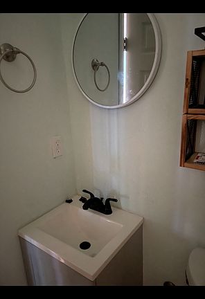Bath faucet and cabinet and mirror.