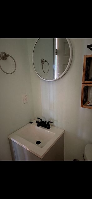 Bath faucet and cabinet and mirror.